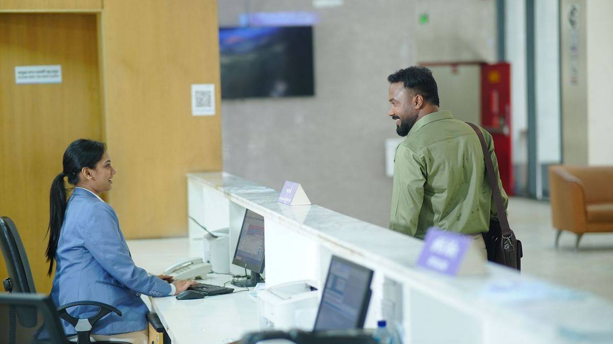 Receptionist assisting a guest at a hotel front desk
